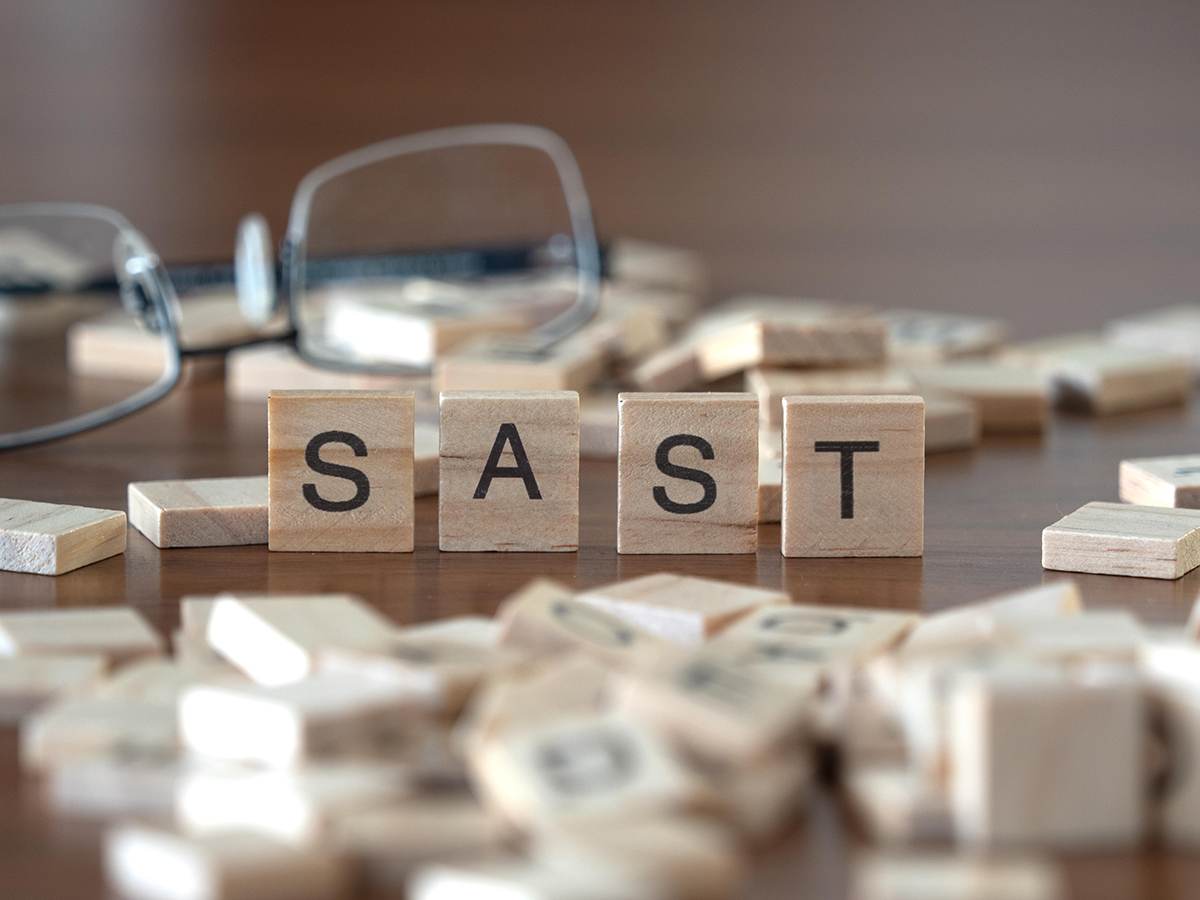 acronym sast for Static Application Security Testing concept represented by wooden letter tiles